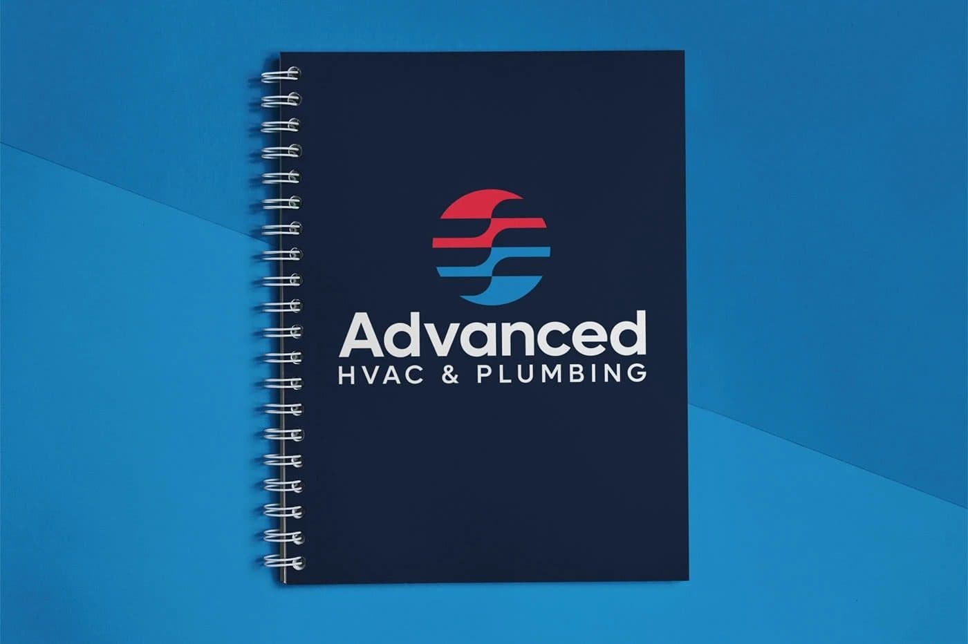 A navy spiral notebook carrying the Advanced HVAC & Plumbing lockup